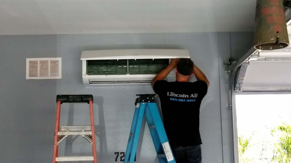 Technician tinkering with an AC system Phoenix, AZ