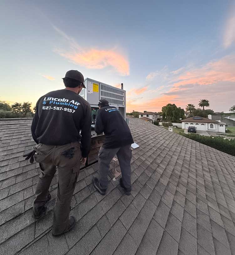 Lincoln Air and Plumbing technicians install a new AC unit in Phoenix, AZ.