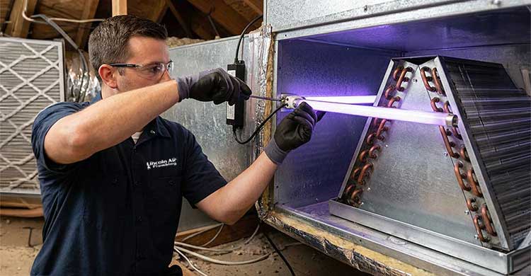 Lincoln Air technician installing a UV air purifier