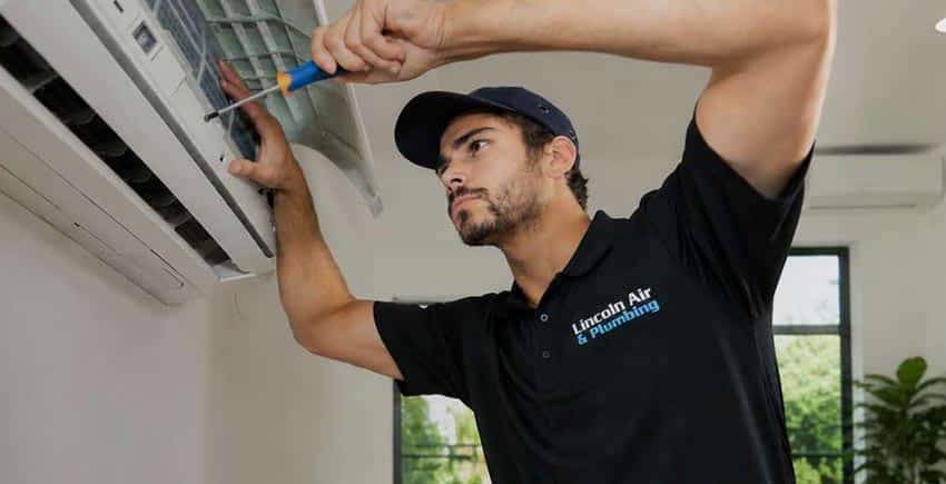 Technician completing a new ductless mini-split installation
