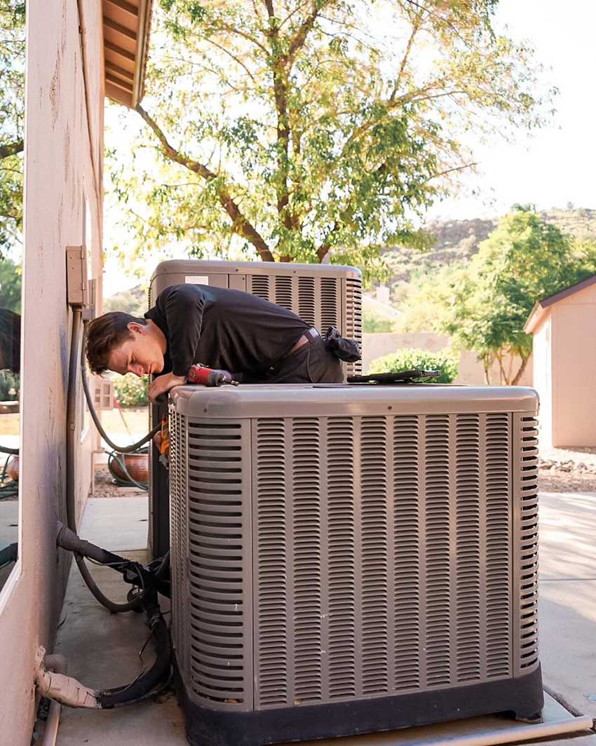 heat pump installer checks electrical connections

