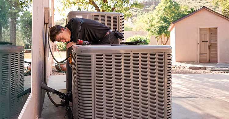 Lincoln Air and Plumbing heating company's technician installing a new heat pump